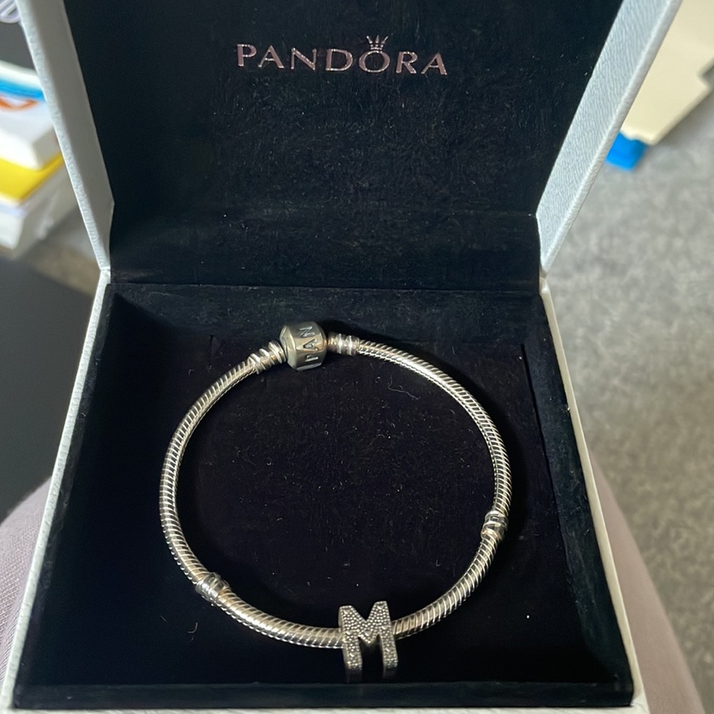 Silver pandora bracelet with “M” charm